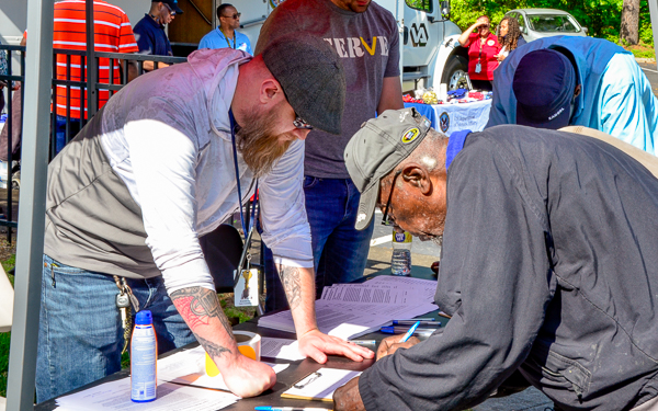 VSC Staff members at a Veteran event helping Veterans sign in